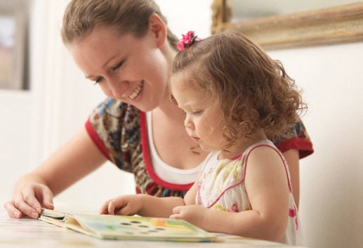 Mother reading to daughter